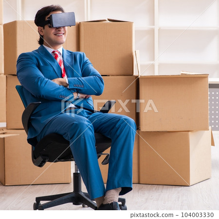 Young handsome businessman moving to new workplace Young handsome businessman moving to new workplace 104003330