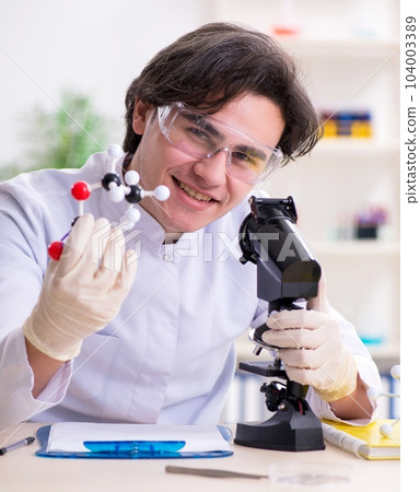 Young male biochemist working in the lab Young male biochemist working in the lab 104003389