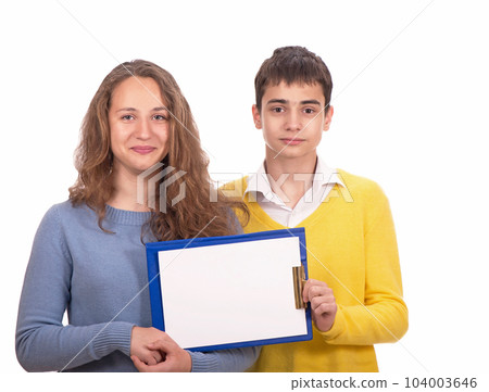 schoolchildren, a girl and a boy are holding a tablet with a blank page, space for text schoolchildren, a girl and a boy are holding a tablet with a blank page, space for text 104003646