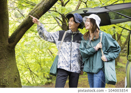 Outdoor drive image A couple arriving at the campsite after the rain 104003854