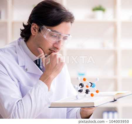 Young male scientist working in the lab Young male scientist working in the lab 104003950