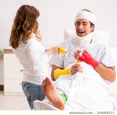 Loving wife looking after injured husband Loving wife looking after injured husband 104004533