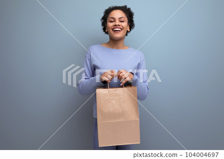happy brunette afro hair woman received delivery of purchase in craft recycled package 104004697