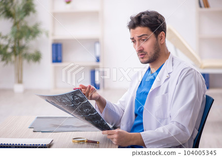 Young male doctor radiologist working in the clinic Young male doctor radiologist working in the clinic 104005345