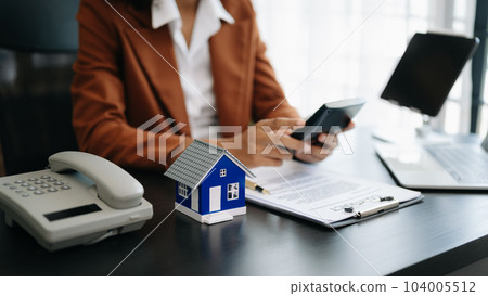 Considering buying a home, investing in real estate. Broker signs a sales agreement. agent, lease agreement, successful deal . 104005512