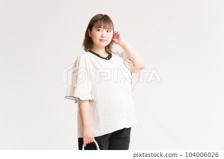 Chubby young woman business casual plus size model 104006026