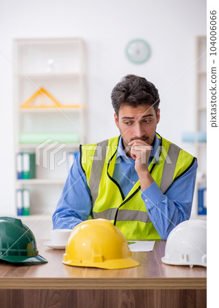 Young male architect working in the office Young male architect working in the office 104006066