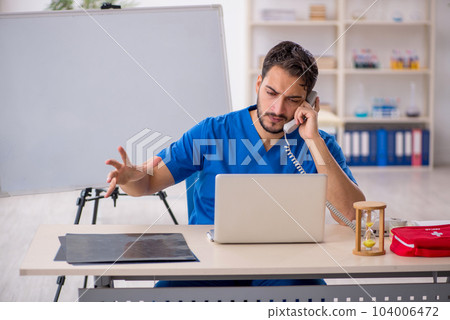Young male doctor in telemedicine concept Young male doctor in telemedicine concept 104006472