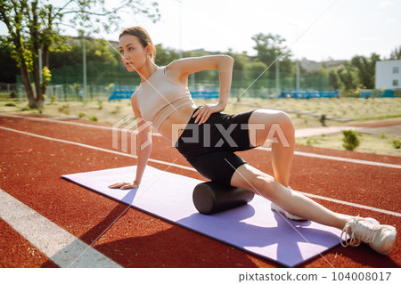 Young woman in sports outfit doing exercises outdoors in morning. Sport, Active life sports training 104008017