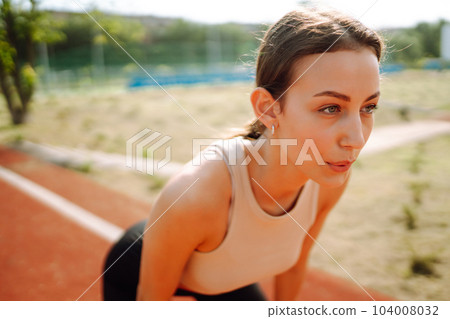 Young woman in sports outfit doing exercises outdoors in morning. Sport, Active life sports training 104008032