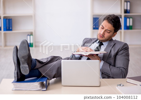 Young male employee working in the office 104008112