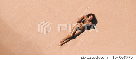 Aerial View of Woman in Bikini on Ideal Pink Sand Beach at the Sea 104008779