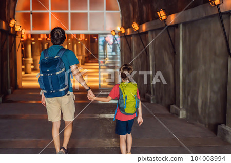 father and son tourists enjoying Beautiful cistern in Istanbul. Cistern - underground water reservoir build in 6th century, Istanbul, Turkey, Turkiye 104008994