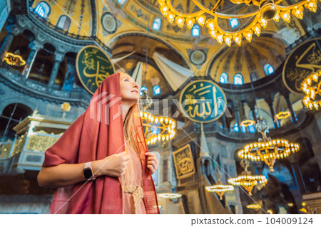 INSCRIPTION - denoting the names of Allah, the Prophet Muhammad, as well as the first 4 caliphs Woman tourist enjoying Hagia Sofia, Ayasofya interior in Istanbul, Turkey, Byzantine architecture, city INSCRIPTION - denoting the names of Allah, the Prophet Muhammad, as well as the first 4 caliphs Woman tourist enjoying Hagia Sofia, Ayasofya interior in Istanbul, Turkey, Byzantine architecture, city 104009124