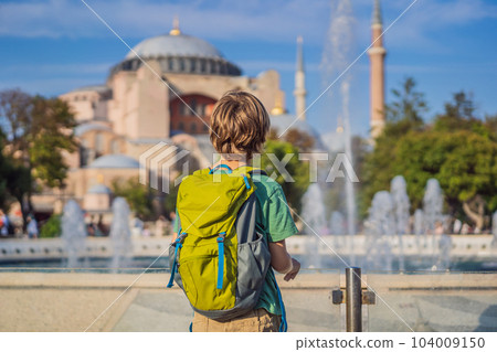 Boy Tourist enjoy beautiful view on Hagia Sophia Cathedral, famous islamic Landmark mosque, Travel to Istanbul, Turkey. Traveling with kids concept. Sunny day architecture and Hagia Sophia Museum, in Boy Tourist enjoy beautiful view on Hagia Sophia Cathedral, famous islamic Landmark mosque, Travel to Istanbul, Turkey. Traveling with kids concept. Sunny day architecture and Hagia Sophia Museum, in 104009150