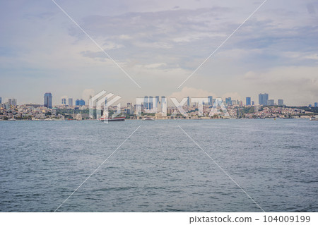 Istanbul at sunset, Turkey. Tourist boat sails on Golden Horn in summer. Beautiful sunny view of Istanbul waterfront with old mosque. Concept of travel, tourism and vacation in Istanbul and Turkey 104009199