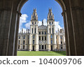 All Souls college, Oxford university - front view of entrance with towers and the green lawn from an archway 104009706