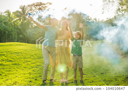 Pregnant mom, dad and son at the gender party on the golf course release blue smoke. Gender reveal announcement on the golf course. Loving family expecting baby boy. Happy moments Pregnant mom, dad and son at the gender party on the golf course release blue smoke. Gender reveal announcement on the golf course. Loving family expecting baby boy. Happy moments 104010647