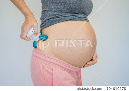 Self-massage with a massager for a pregnant woman 104010678