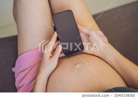 Pregnancy mockup app. Mobile pregnancy online maternity application. Pregnant mother using phone mock up. Pregnancy, medicine, pharmaceutics, health care and people concept Pregnancy mockup app. Mobile pregnancy online maternity application. Pregnant mother using phone mock up. Pregnancy, medicine, pharmaceutics, health care and people concept 104010688