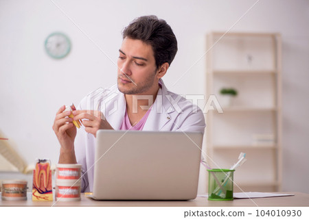 Young male dentist working in the clinic Young male dentist working in the clinic 104010930