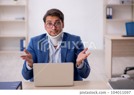 Young male employee after car accident at workplace 104011097