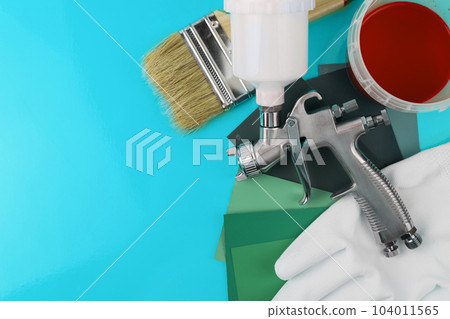 Paint spray gun at work at the workplace in the workshop. Paint Brush 104011565