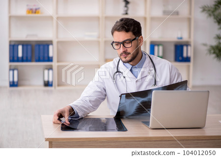 Young male doctor radiologist working in the clinic Young male doctor radiologist working in the clinic 104012050