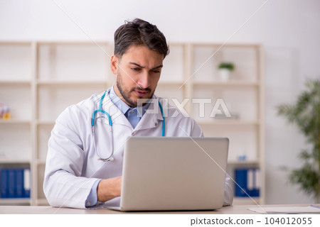 Young male doctor in telemedicine concept Young male doctor in telemedicine concept 104012055