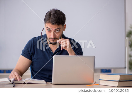 Young male teacher in telestudying concept 104012085