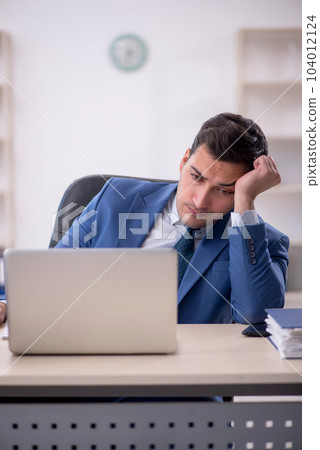 Young male employee working in the office Young male employee working in the office 104012124