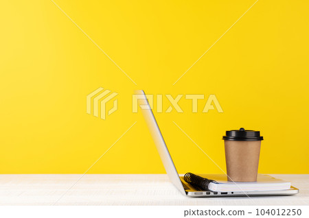 Laptop and coffee cup 104012250