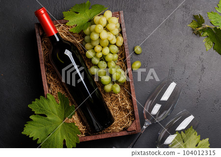 A red wine bottle and fresh grapes 104012315