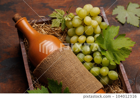 A red wine bottle and fresh grapes 104012316