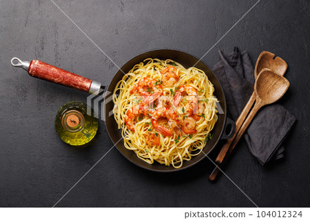 A delightful Italian pasta adorned with shrimps A delightful Italian pasta adorned with shrimps 104012324