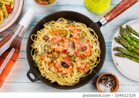 A delightful Italian pasta adorned with shrimps A delightful Italian pasta adorned with shrimps 104012326