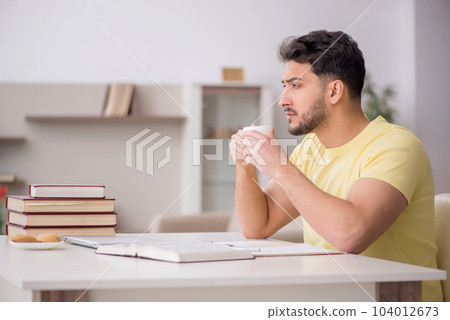 Young male student studying at home Young male student studying at home 104012673