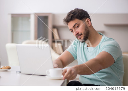 Young male freelancer working from home 104012679