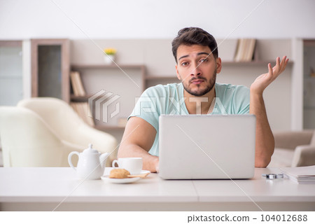 Young male freelancer working from home 104012688