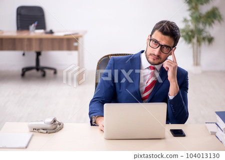 Young male employee working in the office Young male employee working in the office 104013130