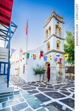 Mykonos, Greece - Cobblestone alley whitewashed village Cyclades Islands 104013287