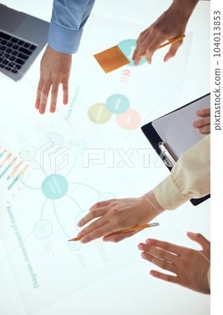 Group of business people are using gadgets and laptop, talking during the conference in office over meeting room background. Brainstorming 104013853