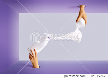 Pop art photography. Female hand sticking out from circle hole with bottle pouring milk into glass. 104015767
