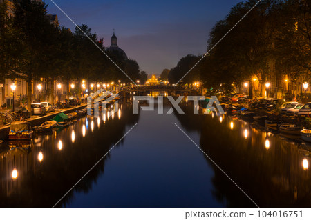 Amsterdam Night Canal With Parked Cars and Boats Amsterdam Night Canal With Parked Cars and Boats 104016751