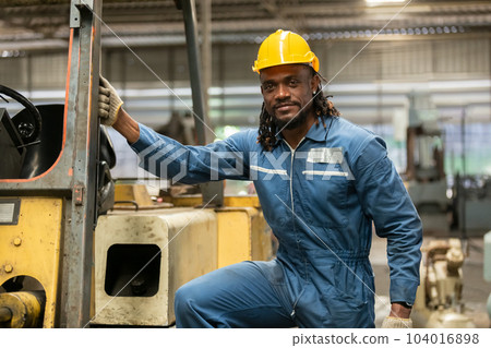 African american worker man wear safety helmet driver forklift warehouse in factory. African american worker man wear safety helmet driver forklift warehouse in factory. 104016898