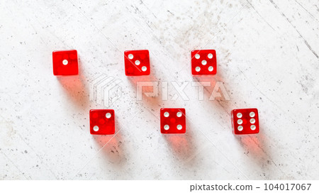 Red translucent craps dices on white board, showing all numbers from 1 to 6 photographed from above 104017067