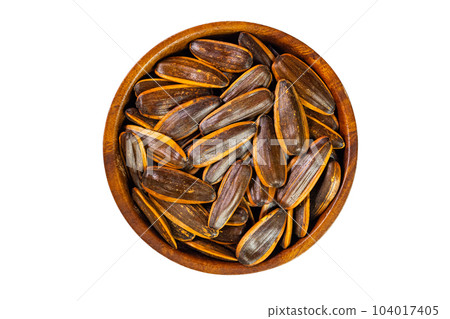 Top view closeup pile of salty roasted sunflower seeds with shell in wooden bowl isolated on white background. Top view closeup pile of salty roasted sunflower seeds with shell in wooden bowl isolated on white background. 104017405