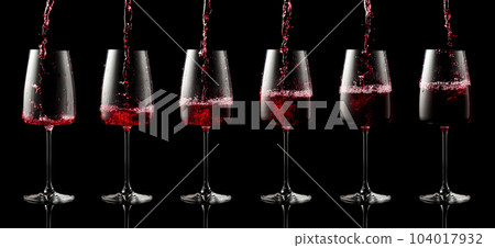Pouring red wine into a glass. 104017932