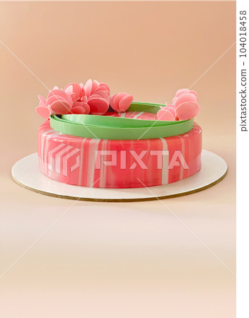 festive pink mousse cake with decor on beige background. copy space. festive pink mousse cake with decor on beige background. copy space. 104018458
