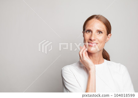 Attractive mature female face, closeup portrait.  104018599